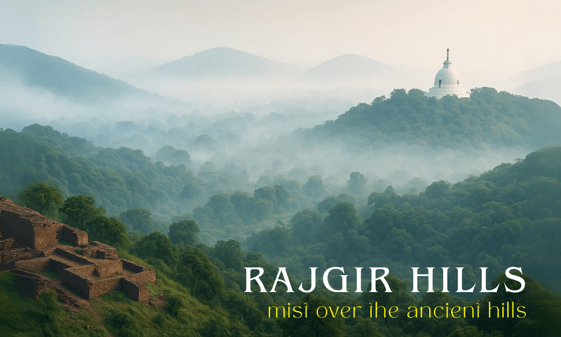 Panoramic view of mist-covered Rajgir Hills at dawn, featuring lush green slopes, ancient stone ruins, and the white Vishwa Shanti Stupa with a golden spire rising above the mist. | Crafts of bihar