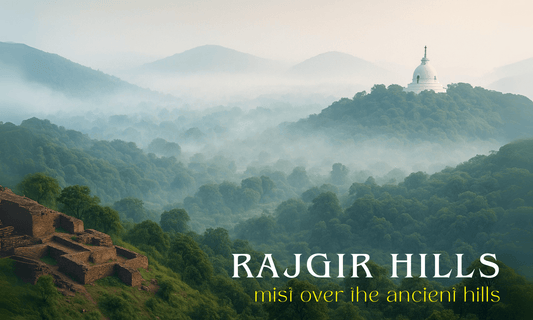 Panoramic view of mist-covered Rajgir Hills at dawn, featuring lush green slopes, ancient stone ruins, and the white Vishwa Shanti Stupa with a golden spire rising above the mist. | Crafts of bihar